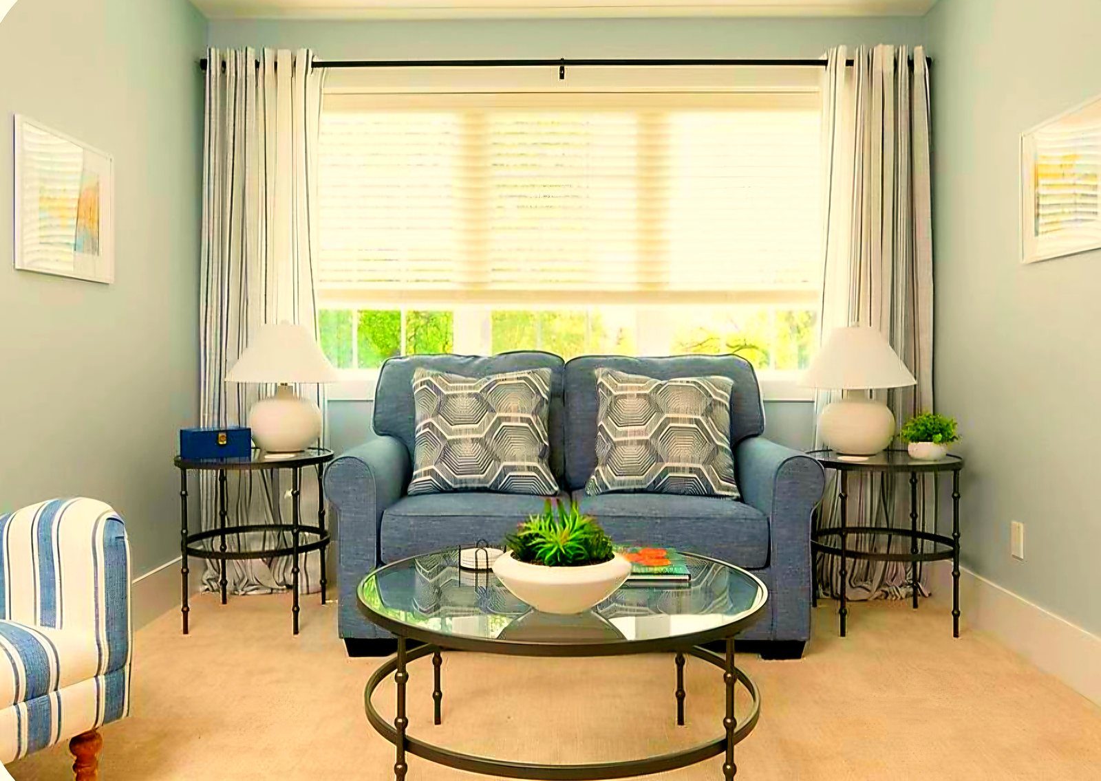 King Suite sitting lounge with blue loveseat and glass coffee table